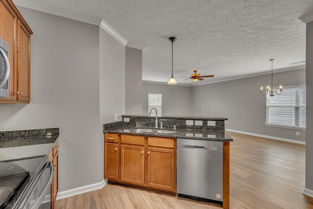1033 Park Run Dr, Franklin, TN 37067 - kitchen with appliances with stainless steel finishes, brown cabinetry, ceiling fan, light wood-type flooring, and a peninsula