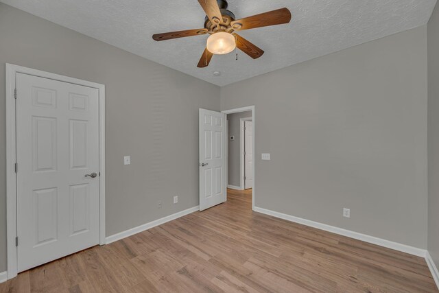 1033 Park Run Dr, Franklin, TN 37067 - unfurnished bedroom featuring light wood-style flooring, a textured ceiling, and ceiling fan
