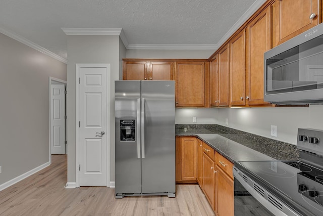 1033 Park Run Dr, Franklin, TN 37067 - kitchen with appliances with stainless steel finishes, brown cabinets, light wood-style floors, crown molding, and dark stone counters