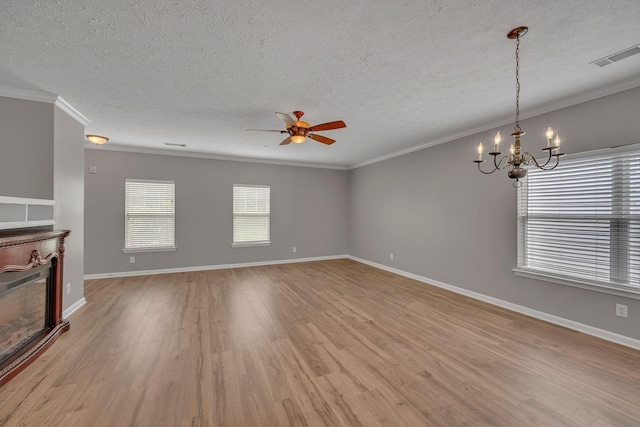 1033 Park Run Dr, Franklin, TN 37067 - unfurnished living room with ornamental molding, ceiling fan, a chandelier, light wood-style floors, and a fireplace