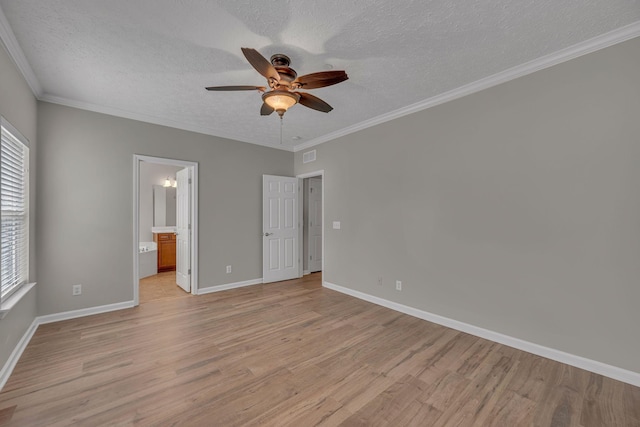 1033 Park Run Dr, Franklin, TN 37067 - unfurnished bedroom featuring light wood-type flooring, multiple windows, a textured ceiling, crown molding, and ensuite bathroom
