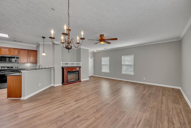 1033 Park Run Dr, Franklin, TN 37067 - unfurnished living room with light wood-type flooring, a ceiling fan, a textured ceiling, a chandelier, and ornamental molding