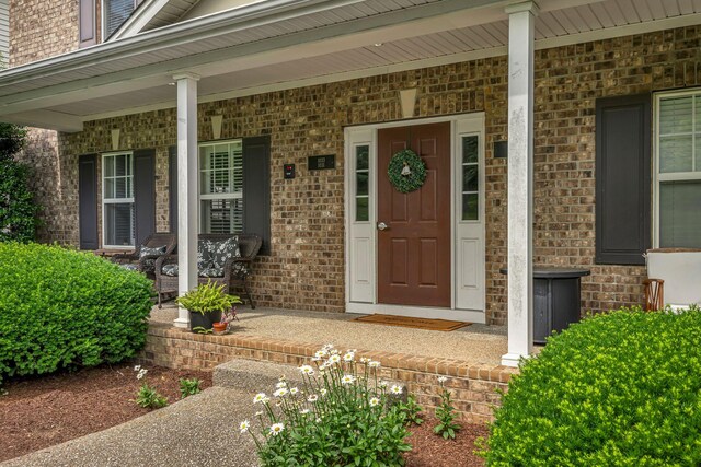 1033 Park Run Dr, Franklin, TN 37067 - doorway to property with covered porch and brick siding