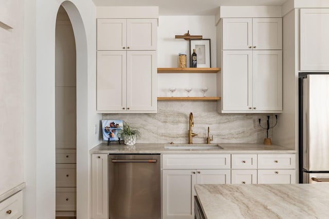 322 Starling Ln, Franklin, TN 37064 - kitchen featuring appliances with stainless steel finishes, backsplash, open shelves, and white cabinetry