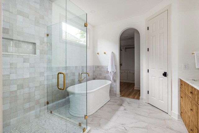 322 Starling Ln, Franklin, TN 37064 - full bath featuring vanity, a freestanding tub, a stall shower, tile walls, and marble finish floors