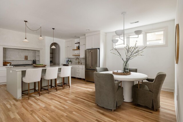 322 Starling Ln, Franklin, TN 37064 - dining area with light wood-style floors and arched walkways