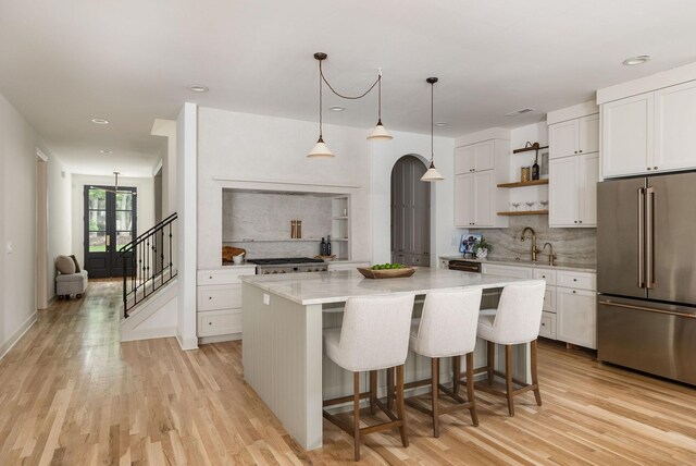 322 Starling Ln, Franklin, TN 37064 - kitchen with high quality fridge, open shelves, backsplash, light wood-style floors, and recessed lighting