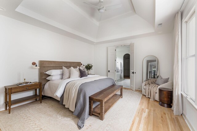 322 Starling Ln, Franklin, TN 37064 - bedroom featuring a tray ceiling, light wood finished floors, and ceiling fan