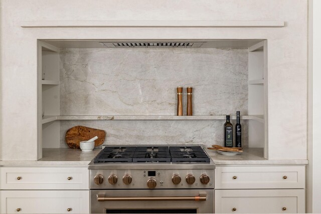 322 Starling Ln, Franklin, TN 37064 - kitchen with stainless steel gas stove, light countertops, and white cabinetry