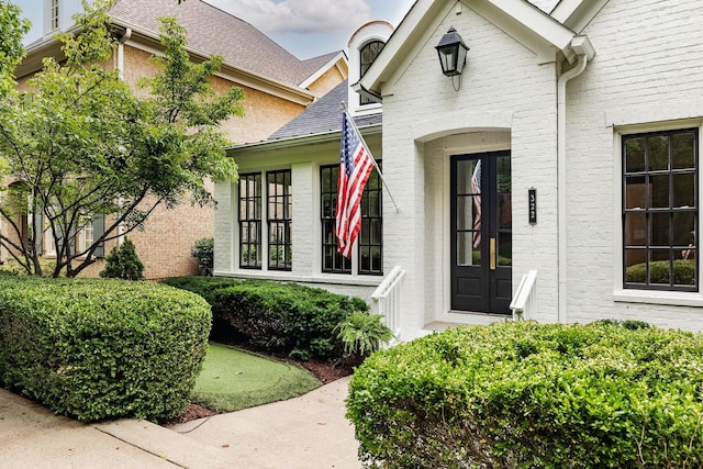 322 Starling Ln, Franklin, TN 37064 - view of exterior entry with a shingled roof and brick siding
