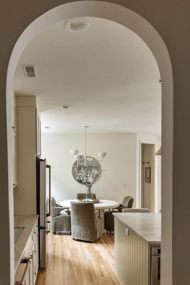 322 Starling Ln, Franklin, TN 37064 - dining room with arched walkways and light wood finished floors