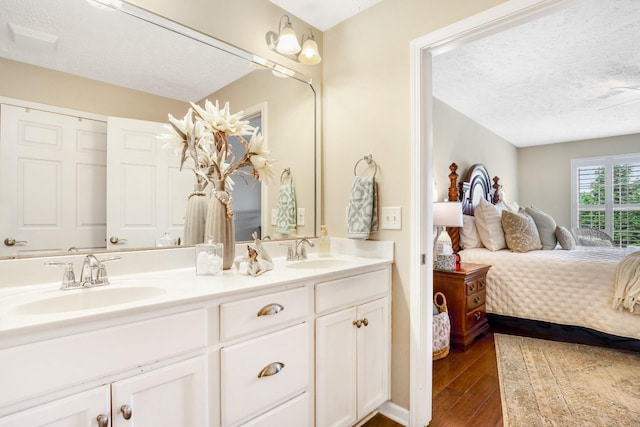 395 Devon Chase Hl Unit 5502, Gallatin, TN 37066 - ensuite bathroom with wood finished floors, a textured ceiling, and double vanity