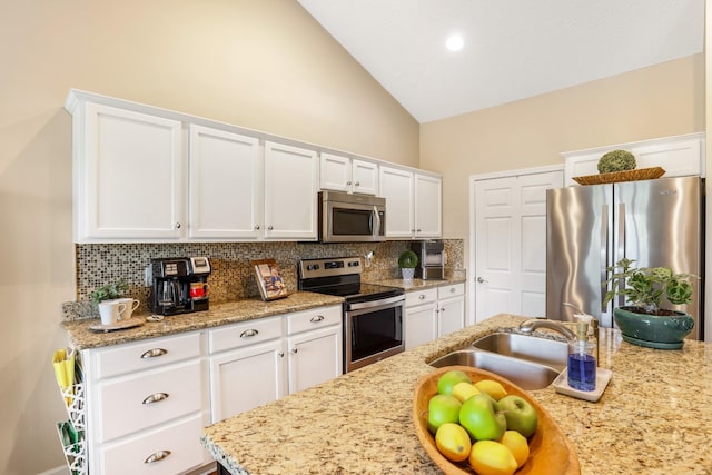 395 Devon Chase Hl Unit 5502, Gallatin, TN 37066 - kitchen with stainless steel appliances, backsplash, white cabinetry, high vaulted ceiling, and light stone counters