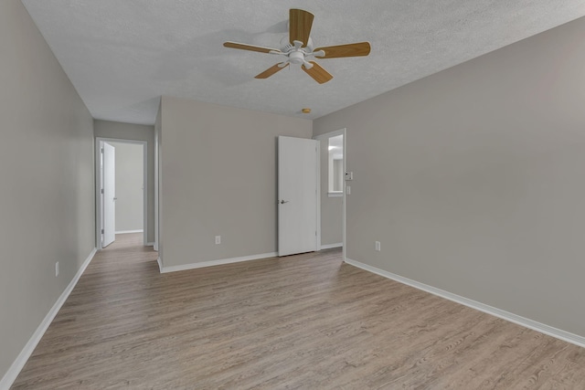7352 Hidden Lake Cir, Fairview, TN 37062 - unfurnished room with light wood finished floors, a ceiling fan, and a textured ceiling