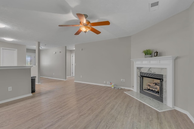 7352 Hidden Lake Cir, Fairview, TN 37062 - unfurnished living room with a fireplace, a ceiling fan, and light wood-type flooring