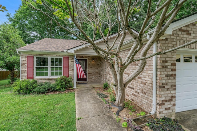 7352 Hidden Lake Cir, Fairview, TN 37062 - view of front of property featuring brick siding, an attached garage, a front lawn, and roof with shingles