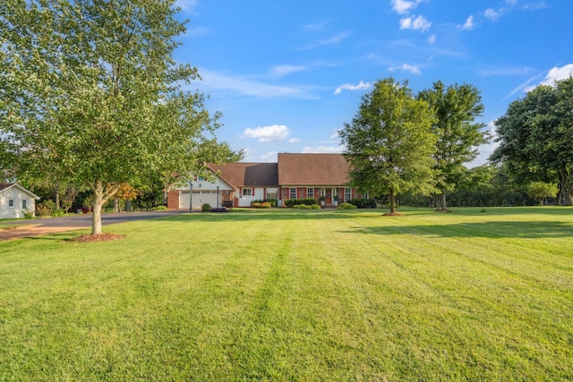 5013 Baker Rd, Murfreesboro, TN 37129 - view of grassy yard with driveway and an attached garage
