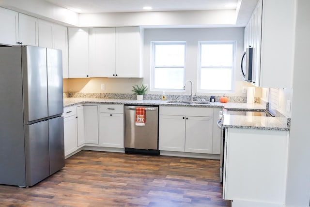 413 E Main St, Waverly, TN 37185 - kitchen featuring appliances with stainless steel finishes, dark wood finished floors, white cabinetry, light stone counters, and recessed lighting