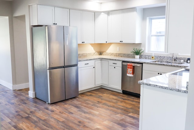 413 E Main St, Waverly, TN 37185 - kitchen featuring appliances with stainless steel finishes, dark wood-type flooring, and white cabinets