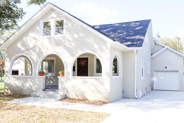 413 E Main St, Waverly, TN 37185 - view of front of home featuring a shingled roof, brick siding, a porch, concrete driveway, and a garage