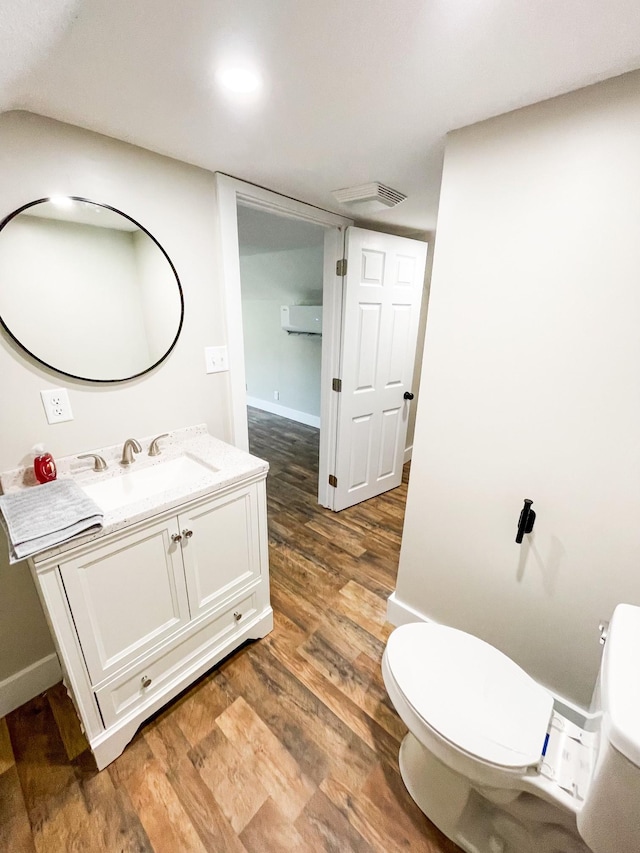 413 E Main St, Waverly, TN 37185 - bathroom with vanity, wood finished floors, and an AC wall unit