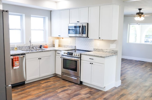 413 E Main St, Waverly, TN 37185 - kitchen with appliances with stainless steel finishes, dark wood-type flooring, white cabinets, and plenty of natural light