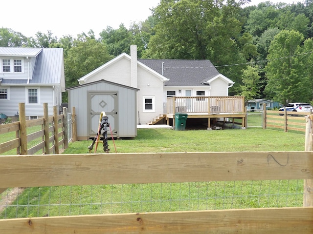 413 E Main St, Waverly, TN 37185 - back of house featuring a deck, a storage unit, and a fenced backyard