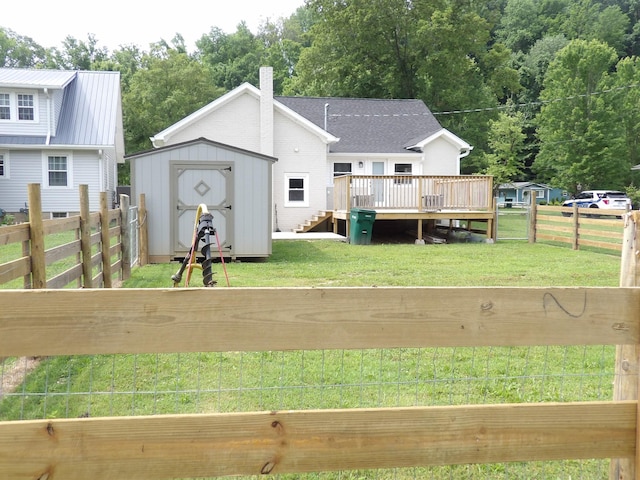 413 E Main St, Waverly, TN 37185 - rear view of property featuring a deck, a shed, a fenced backyard, and a chimney