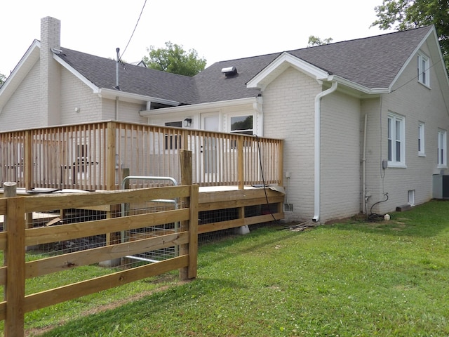 413 E Main St, Waverly, TN 37185 - back of property featuring brick siding, a chimney, a shingled roof, and a wooden deck