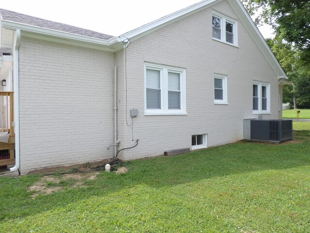 413 E Main St, Waverly, TN 37185 - back of house featuring brick siding, a lawn, and a shingled roof