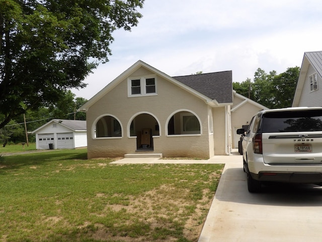 413 E Main St, Waverly, TN 37185 - traditional-style house with roof with shingles, a front yard, brick siding, and a detached garage