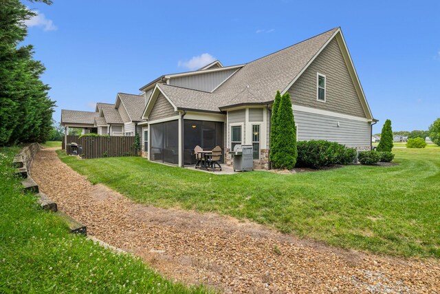 146 Island Way, Winchester, TN 37398 - back of property featuring roof with shingles, a sunroom, and a patio area