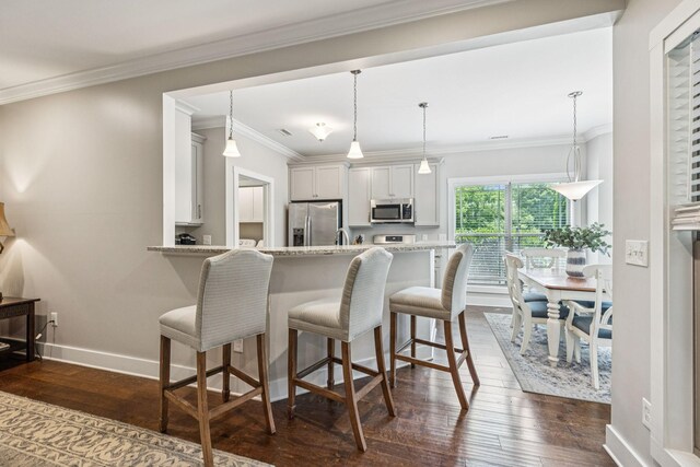 146 Island Way, Winchester, TN 37398 - kitchen featuring stainless steel appliances, dark wood-type flooring, a kitchen breakfast bar, light stone counters, and ornamental molding