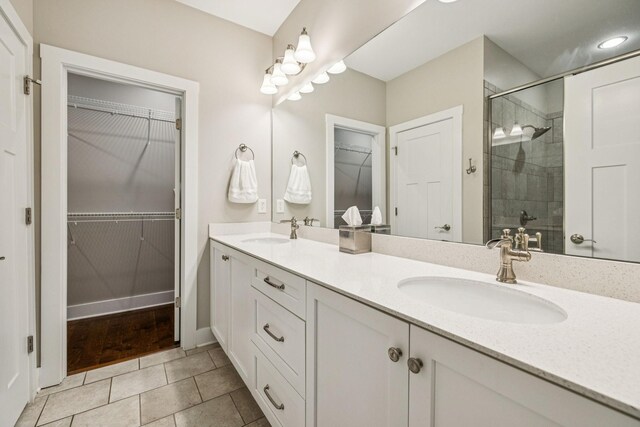 146 Island Way, Winchester, TN 37398 - full bath with double vanity, a stall shower, a walk in closet, and tile patterned flooring