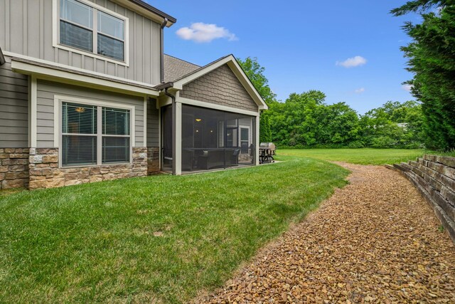 146 Island Way, Winchester, TN 37398 - back of property with board and batten siding, a sunroom, stone siding, and a yard