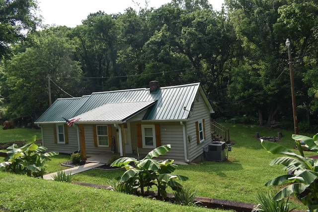 34 Thompson Hollow Rd, Carthage, TN 37030 - view of front of house with a chimney, a front lawn, a metal roof, and a standing seam roof