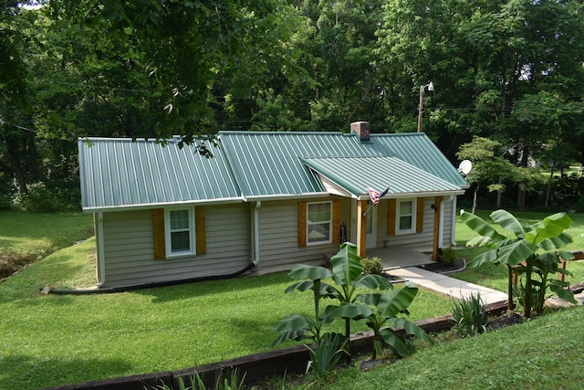 34 Thompson Hollow Rd, Carthage, TN 37030 - rear view of property featuring a metal roof, a yard, a chimney, and covered porch