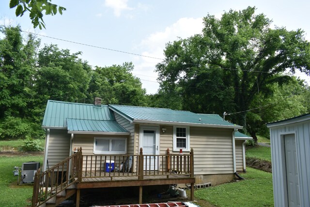 34 Thompson Hollow Rd, Carthage, TN 37030 - back of house featuring a yard, a metal roof, a chimney, and a wooden deck