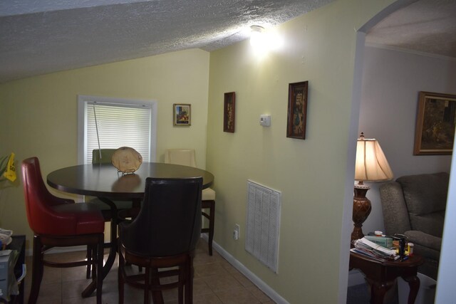 34 Thompson Hollow Rd, Carthage, TN 37030 - dining area with arched walkways, tile patterned flooring, vaulted ceiling, a textured ceiling, and ornamental molding