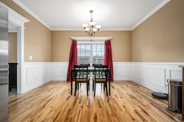 2816 Lightning Bug Dr, Murfreesboro, TN 37129 - dining space with a chandelier, ornamental molding, light wood-style flooring, a wainscoted wall, and a decorative wall