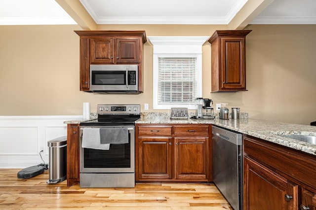 2816 Lightning Bug Dr, Murfreesboro, TN 37129 - kitchen featuring stainless steel appliances, light wood finished floors, ornamental molding, and light stone counters