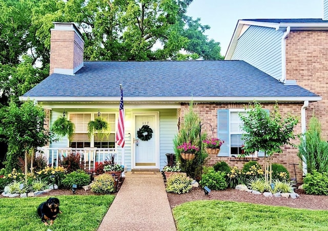 117 Cumberland Trce, Nashville, TN 37214 - bungalow-style house with a chimney, roof with shingles, brick siding, and covered porch