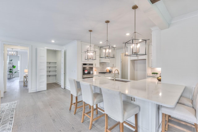 4025 Singing Creek Dr, Franklin, TN 37064 - kitchen featuring decorative backsplash, light countertops, white cabinets, recessed lighting, and light wood-style flooring