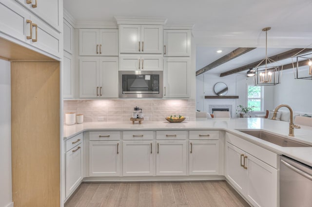 4025 Singing Creek Dr, Franklin, TN 37064 - kitchen with appliances with stainless steel finishes, a fireplace, white cabinets, light countertops, and beam ceiling