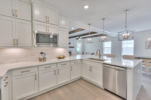 4025 Singing Creek Dr, Franklin, TN 37064 - kitchen with stainless steel appliances, light wood-type flooring, a peninsula, decorative backsplash, and beam ceiling