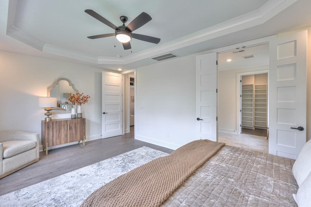 4025 Singing Creek Dr, Franklin, TN 37064 - bedroom with wood finished floors, a tray ceiling, a walk in closet, recessed lighting, and ceiling fan