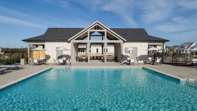 8031 Southvale Blvd, Franklin, TN 37064 - rear view of house featuring a patio area, a community pool, and brick siding