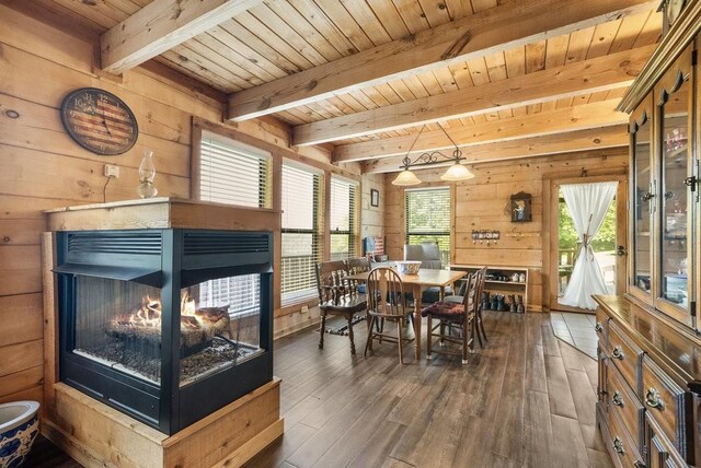 2875 Stage Coach Rd, Sewanee, TN 37375 - dining area featuring a multi sided fireplace, a wood ceiling with exposed beams, wood walls, and hardwood / wood-style flooring