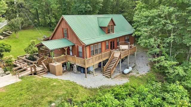 2875 Stage Coach Rd, Sewanee, TN 37375 - rear view of property featuring stairs, a metal roof, a wooden deck, and a forest view