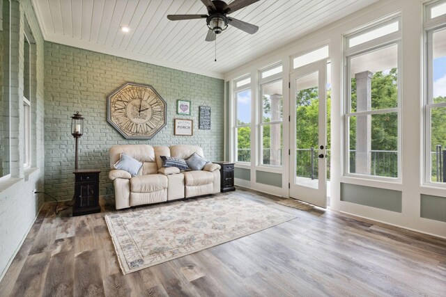 6013 Blackwell Ln, Franklin, TN 37064 - sunroom / solarium with brick wall, wood finished floors, wooden ceiling, and a wood stove
